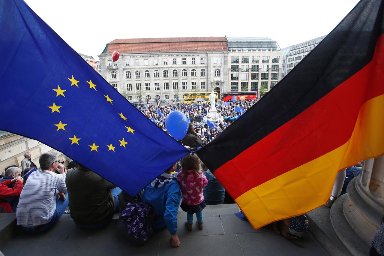 FILE PHOTO: Participants of the Pro-Europe "Pulse of Europe" movement hold European Union and German flags during a protest at Gendarmenmarkt square in Berlin
