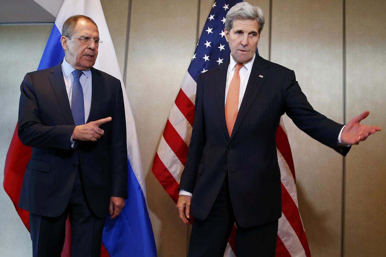 U.S. Foreign Secretary John Kerry and Russian Foreign Minister Sergei Lavrov (L) gesture before their bilateral talks in Munich, Germany, February 11, 2016, ahead of the International Syria Support Group (ISSG) meeting. REUTERS/Michael Dalder   TPX IMAGES