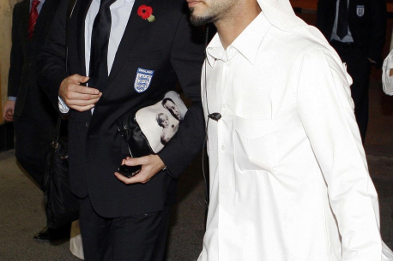 'England soccer captain John Terry (L) arrives at Doha airport November 11, 2009. England will play Brazil in an international friendly soccer match in Doha on November 14. REUTERS/Mohamad Dabbouss (Q