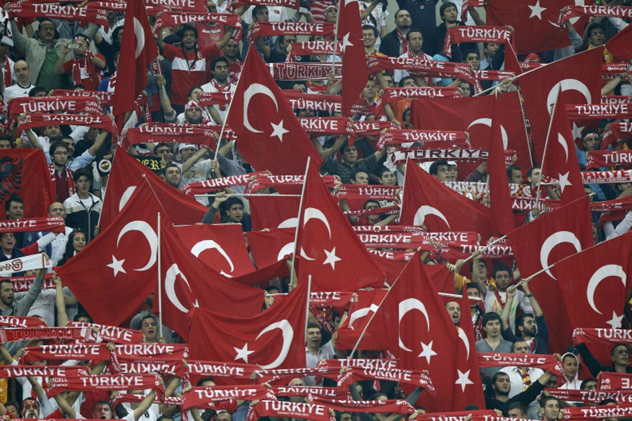 'Turkey fans wave flags before the start of the Euro 2012 qualifying Group A soccer match between Turkey and Germany at Turk Telekom Arena in Istanbul October 7, 2011.          REUTERS/Murad Sezer (TU