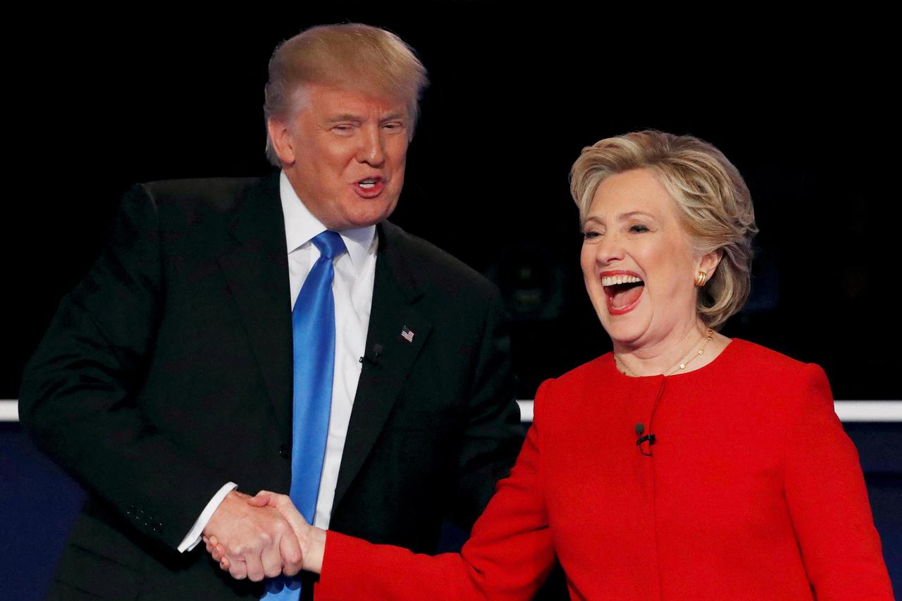 FILE PHOTO: Republican U.S. presidential nominee Donald Trump shakes hands with Democratic U.S. presidential nominee Hillary Clinton at the conclusion of their first presidential debate at Hofstra University in Hempstead