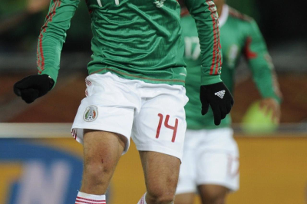 'Mexico\'s striker Javier Hernandez celebrates after acoring during their Group A first round 2010 World Cup football match on June 17, 2010 at Peter Mokaba stadium in Polokwane. NO PUSH TO MOBILE / M