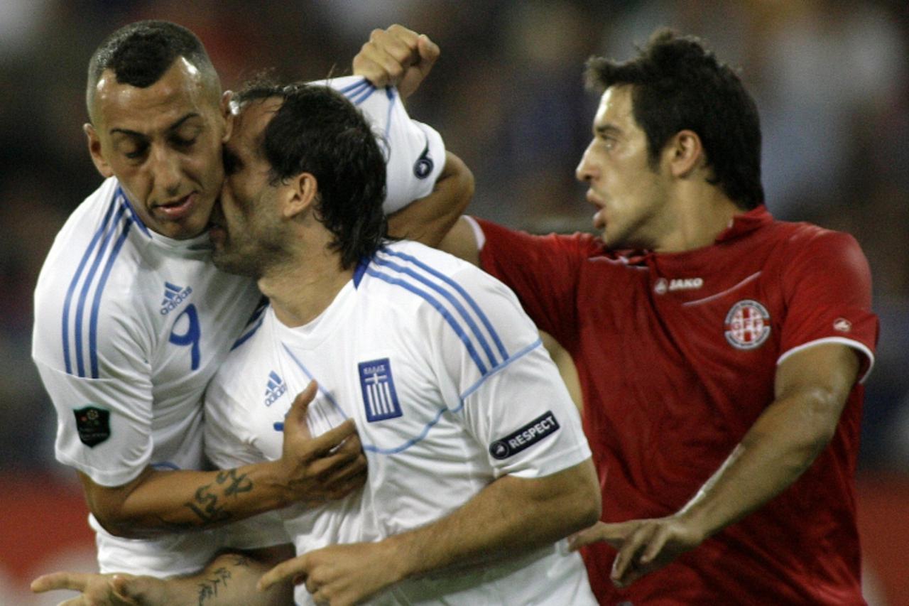 \'Greece players Konstantinos Mitroglou (L) and Theofanis Gekas (C) compete with Kakha Kaladze (R) of Georgia during their Euro 2012 qualifying group F football match at Karaiskaki stadium in Athens o