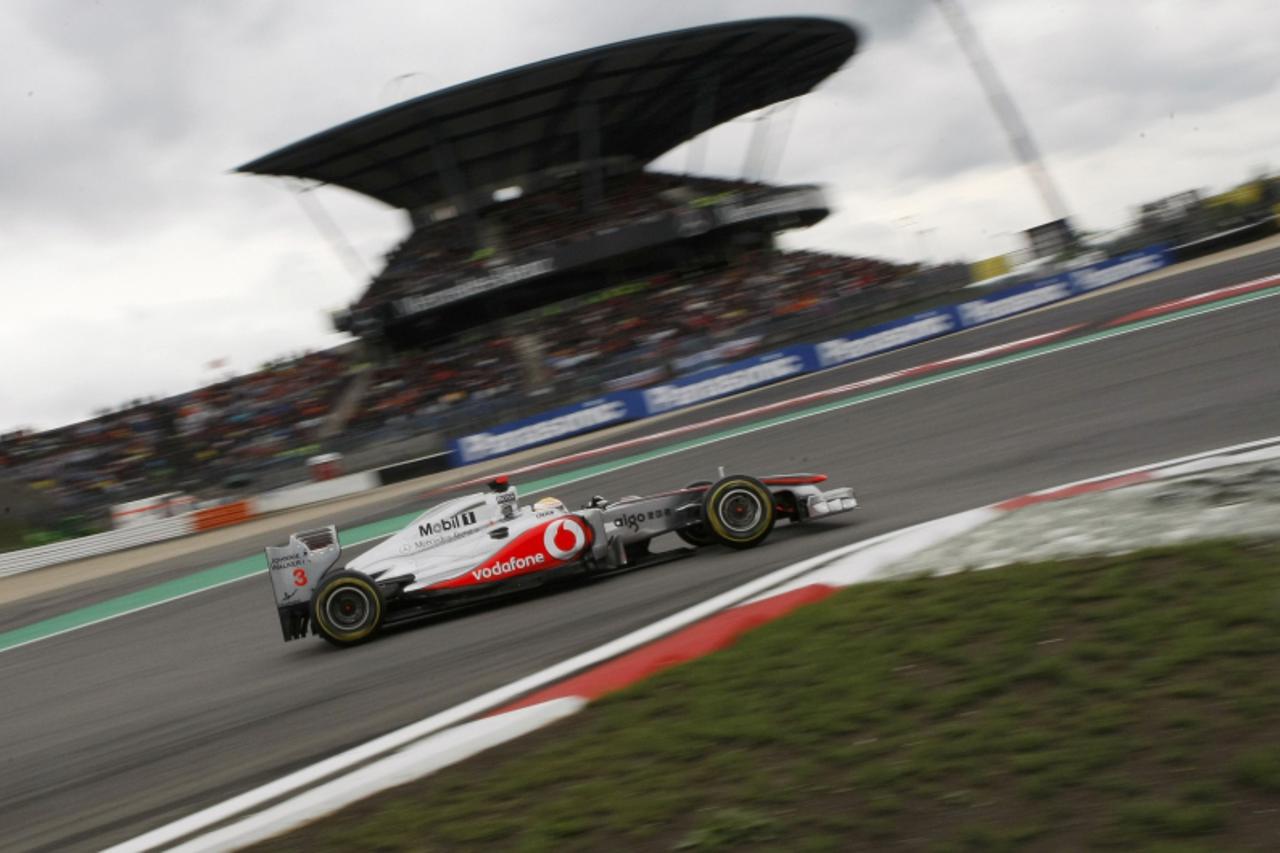 'McLaren Formula One driver Lewis Hamilton of Britain takes a corner during the German F1 Grand Prix at the Nuerburgring circuit, July 24, 2011.   REUTERS/Alex Domanski (GERMANY  - Tags: SPORT MOTOR R