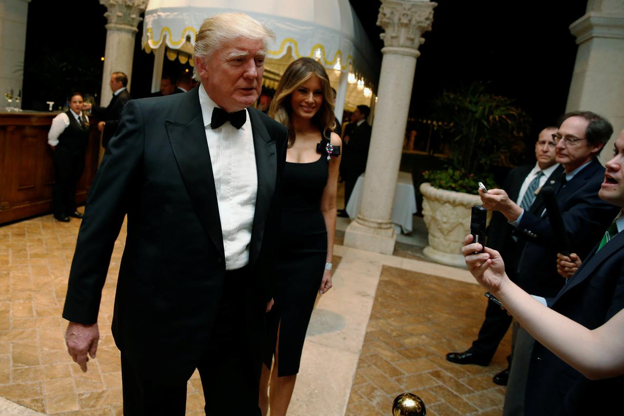 U.S. President-elect Donald Trump talks to reporters as he and his wife Melania Trump arrive for a New Year's Eve celebration with members and guests at the Mar-a-lago Club in Palm Beach, Florida, U.S. December 31, 2016. REUTERS/Jonathan Ernst