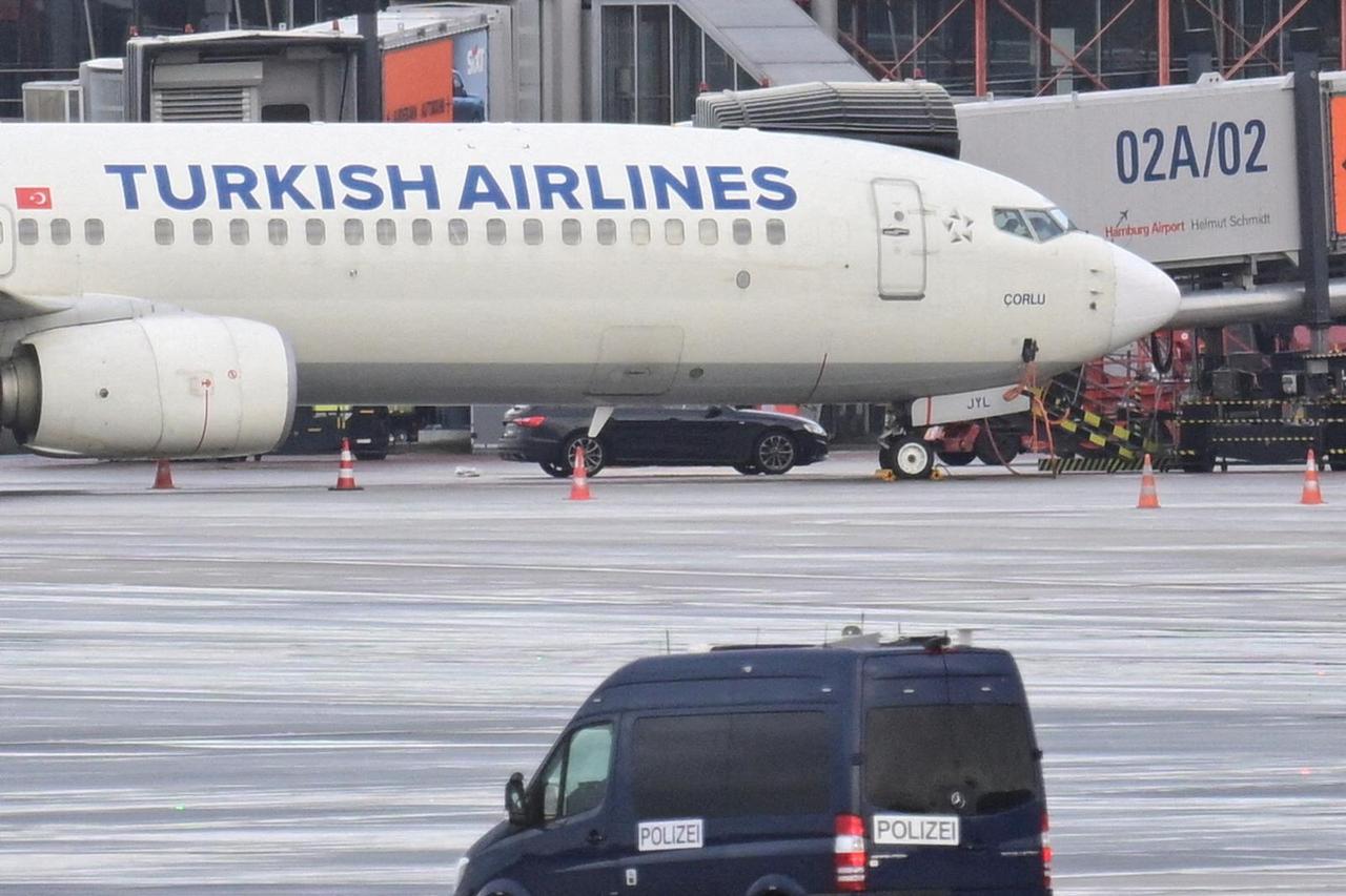 A car that was used by a man who drove through a barrier onto the grounds of the city's airport with a child, is parked next to a plane, in Hamburg