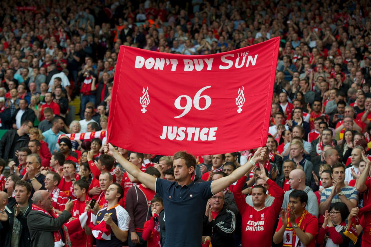 LIVERPOOL, ENGLAND - Sunday September 2, 2012: A Liverpool supporter with a banner 'Don't Buy The Sun - 96 Justice' during the Premiership match against Arsenal at Anfield. (Pic by David Rawcliffe/Propaganda)