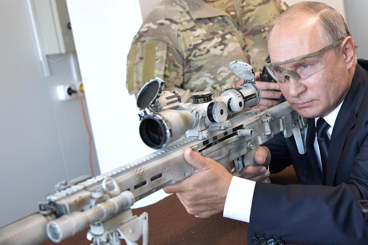 FILE PHOTO: Russian President Putin aims a Chukavin sniper rifle SVCh-308 at Patriot military theme park outside Moscow