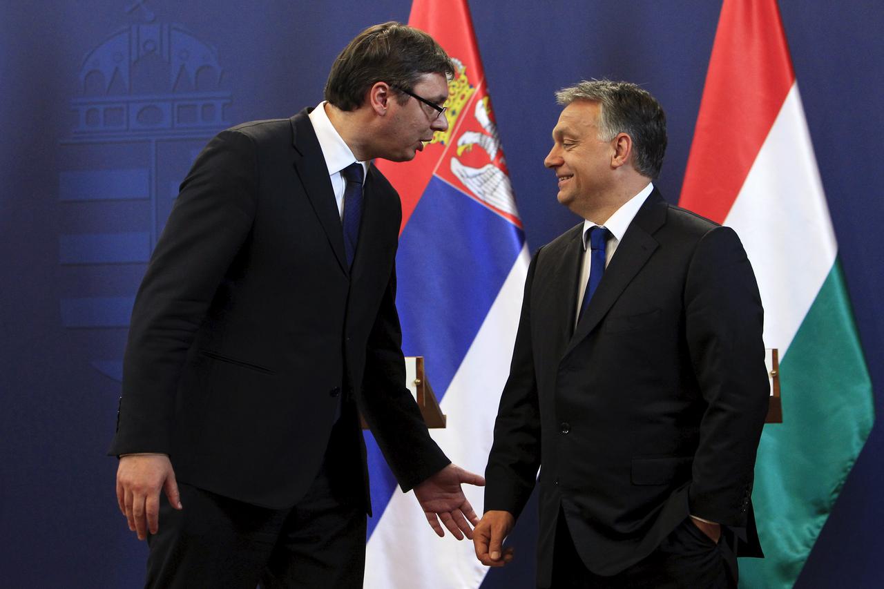 Hungarian Prime Minister Viktor Orban (R) and Serbian Prime Minister Aleksandar Vucic talk after a joint news conference in Budapest, Hungary, July 1, 2015. REUTERS/Bernadett Szabo - RTX1ILHU