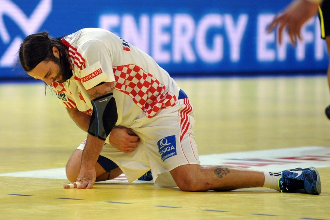 'Croatia\'s Ivano Balic reacts in pain during the men\'s EHF Euro 2012 Handball Championship semifinal match Serbia vs Croatia on January 27, 2012 at the Beogradska Arena in Belgrade. Serbia won 26 - 