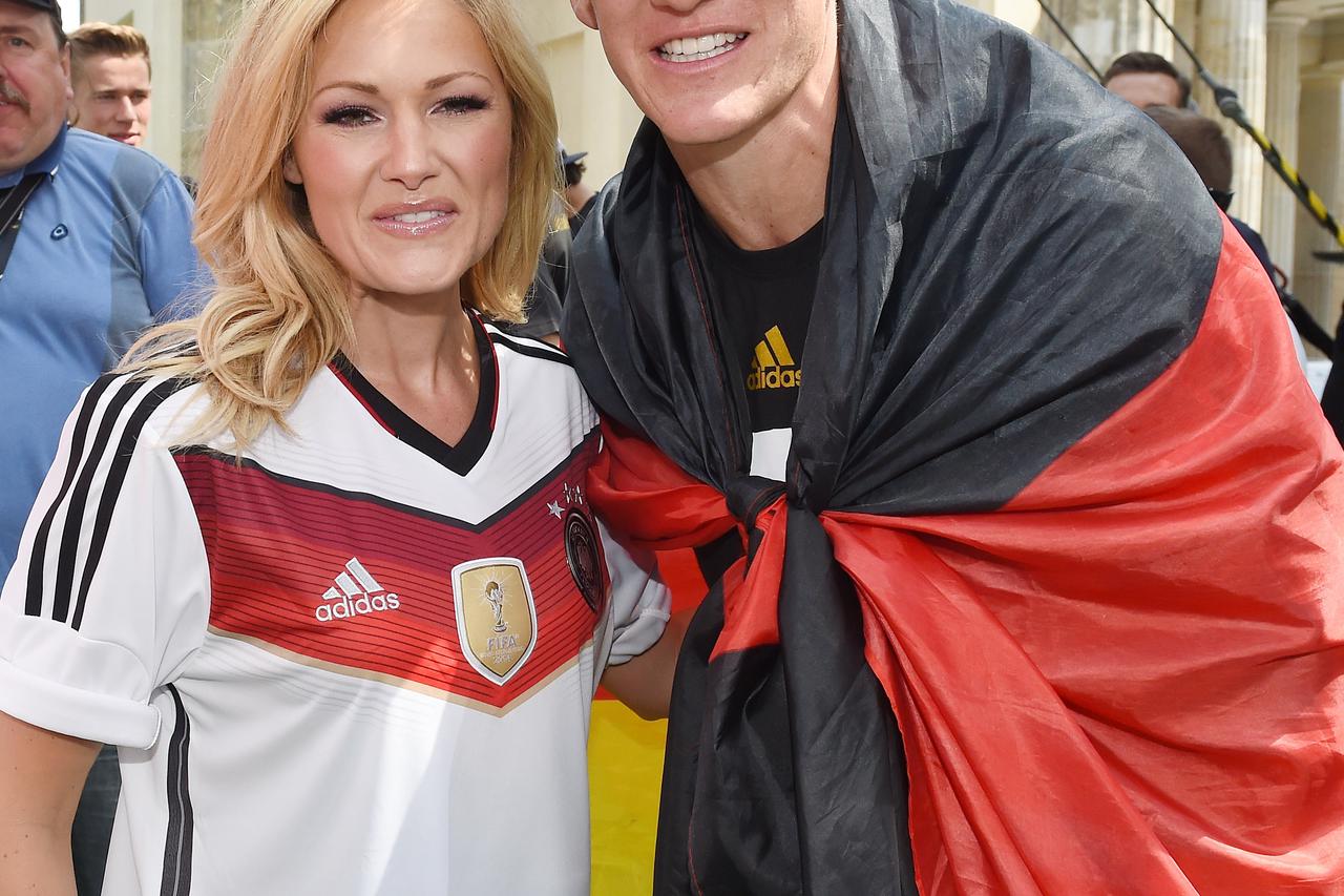 Singer Helene Fischer and Germany's Bastian Schweinsteiger during the World Cup party after team German arrived back in German in front of the Brandenburg Gate in Berlin, Germany, 15 July 2014. The German team won the Brazil 2014 FIFA Soccer World Cup fin
