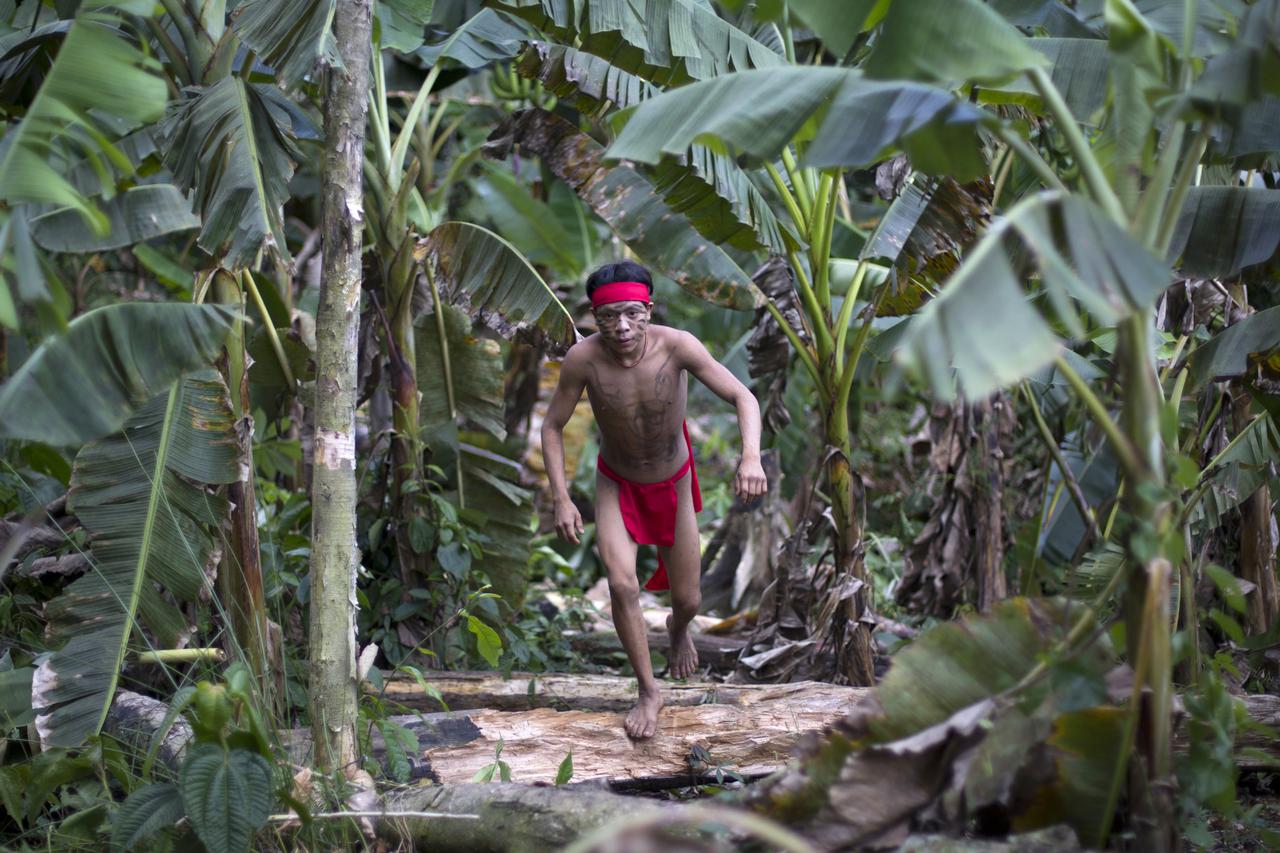 A Yanomami Indian runs in the jungle at the community of Irotatheri, during a government trip for journalists, in the southern Amazonas state of Venezuela, just 19km (12 miles) from Brazil's border, September 7, 2012. The Venezuela government and indigeno