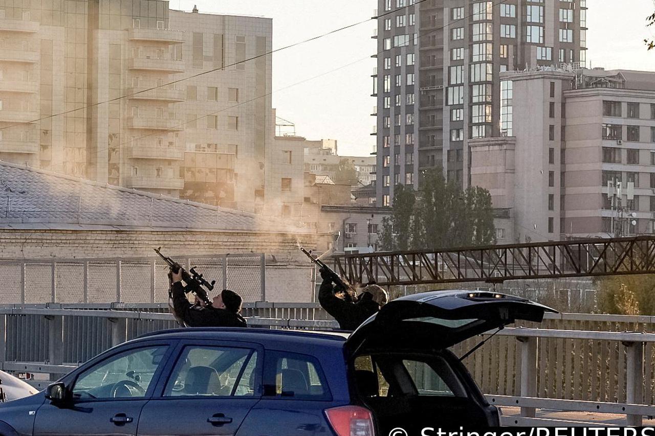 FILE PHOTO: Police officers shoot at a drone during a Russian drone strike in Kyiv