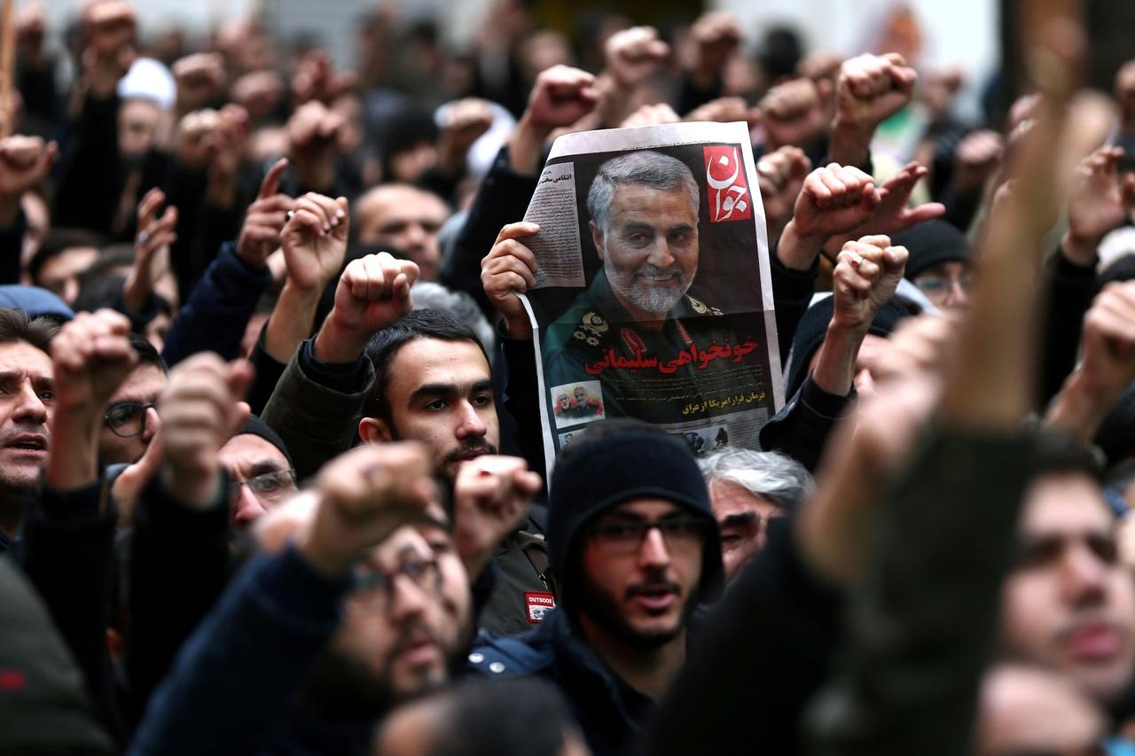 FILE PHOTO: Iranians gesture as they gather to mourn General Qassem Soleimani in Tehran