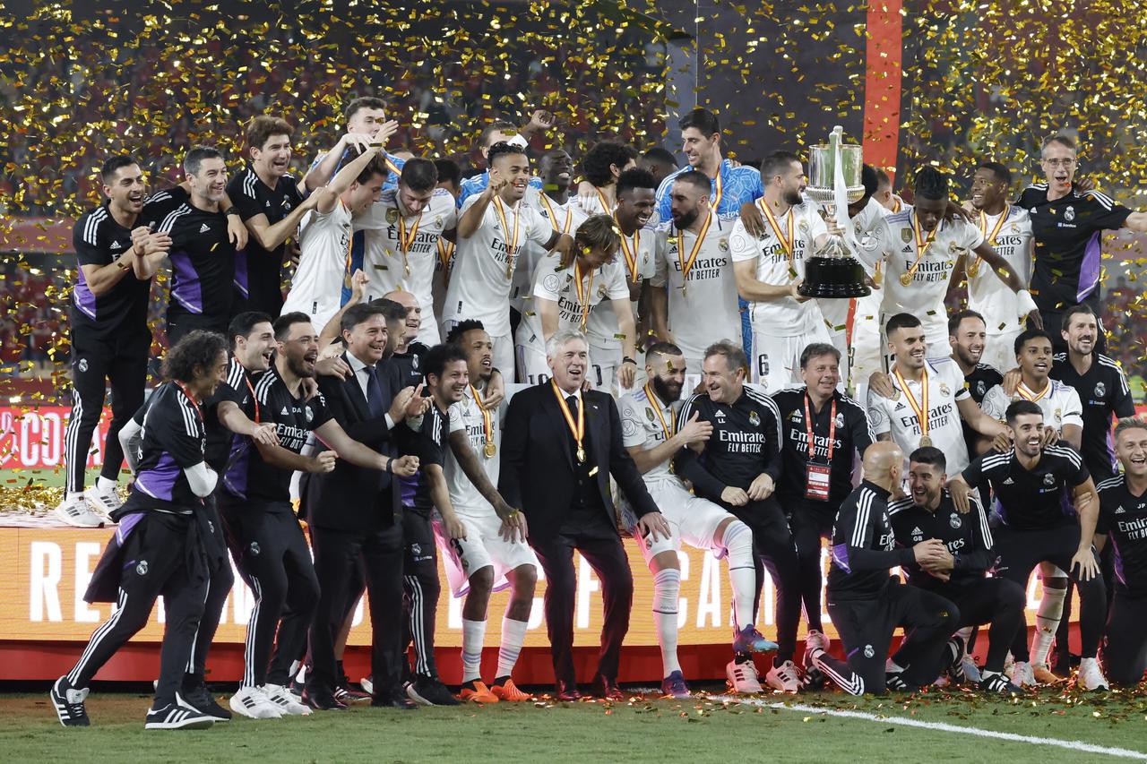 Real Madrid celebrate with the trophy