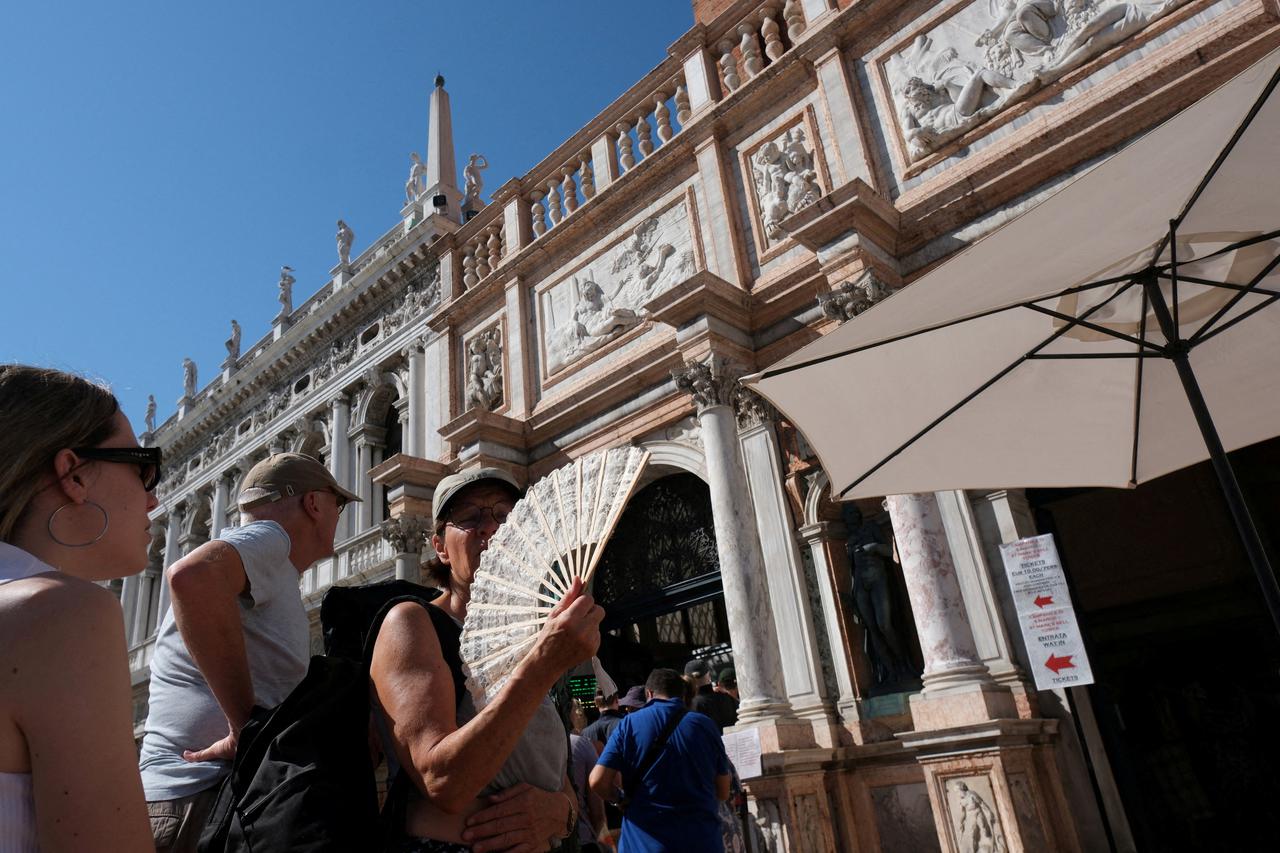 FILE PHOTO: Tourists wait to enter St. Mark's bell tower in Venice