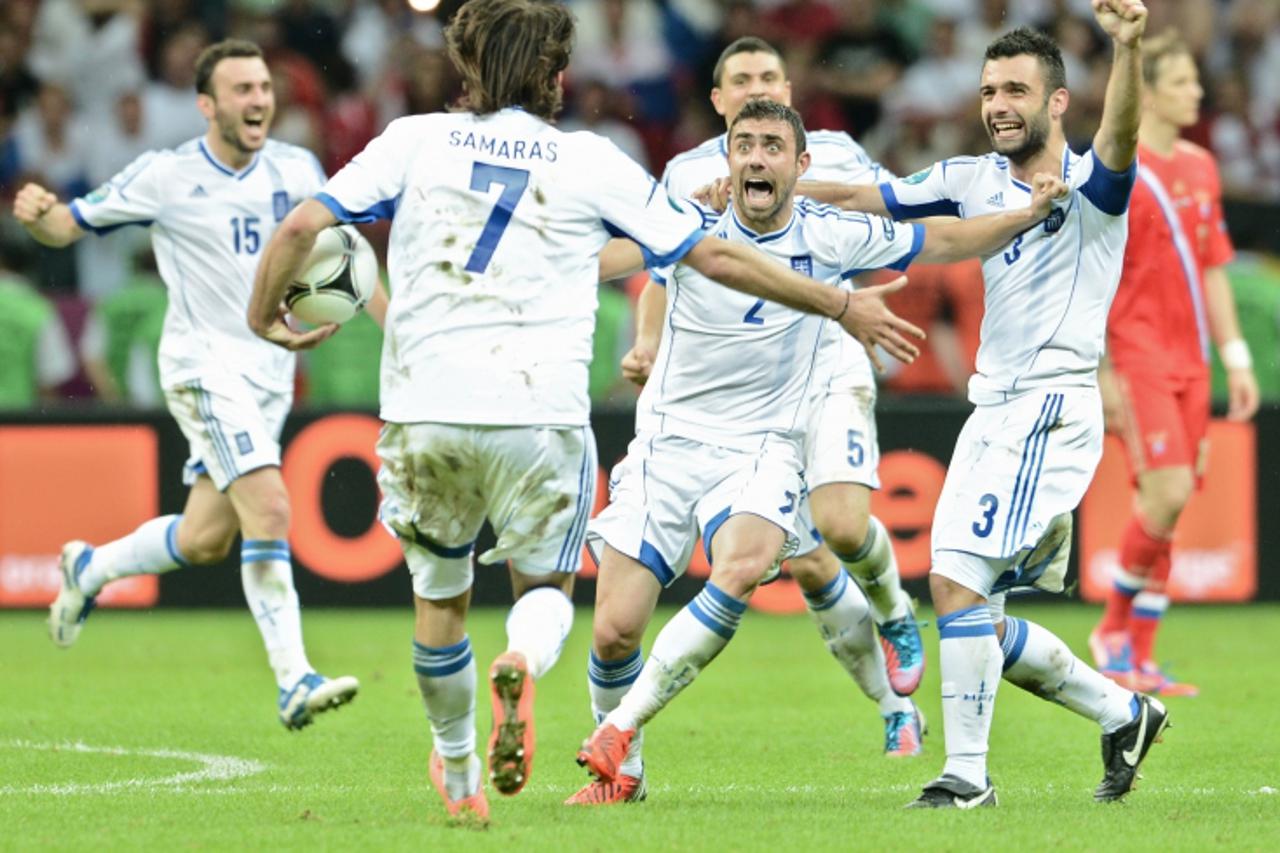 'Greek players celebrate after the Euro 2012 championships football match Greece vs Russia on June 16, 2012 at the National Stadium in Warsaw.    AFP PHOTO / ARIS MESSINIS'