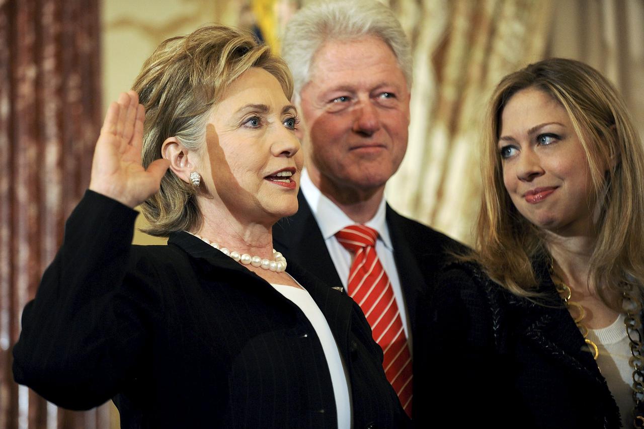 US Secretary of State Hillary Clinton (L) is joined by her husband former U.S. President Bill Clinton and daughter Chelsea Clinton as she is ceremonially sworn in at the State Department in Washington, in this February 2, 2009 file photo. Hillary Clinton 