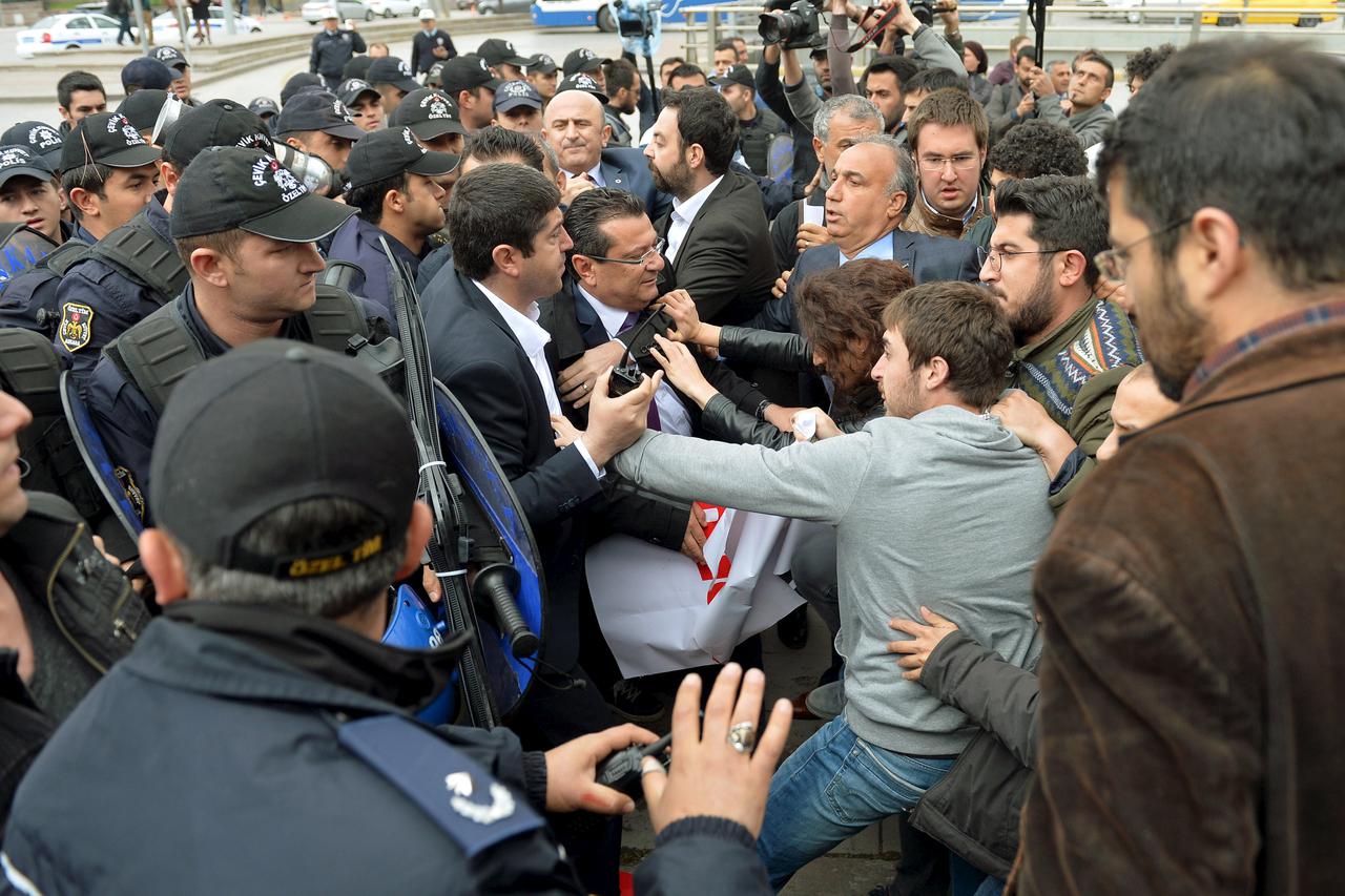 Riot police scuffle with demonstrators during a protest against parliament speaker Ismail Kahraman, outside the Turkish parliament in Ankara, Turkey April 26, 2016. 