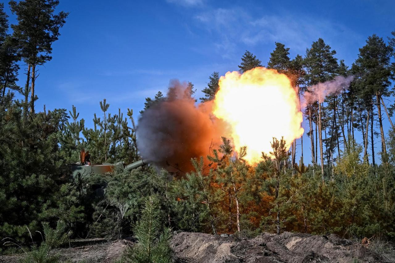 Ukrainian servicemen fire towards Russian troops on self-propelled AHS Gvozdika howitze in Kharkiv region