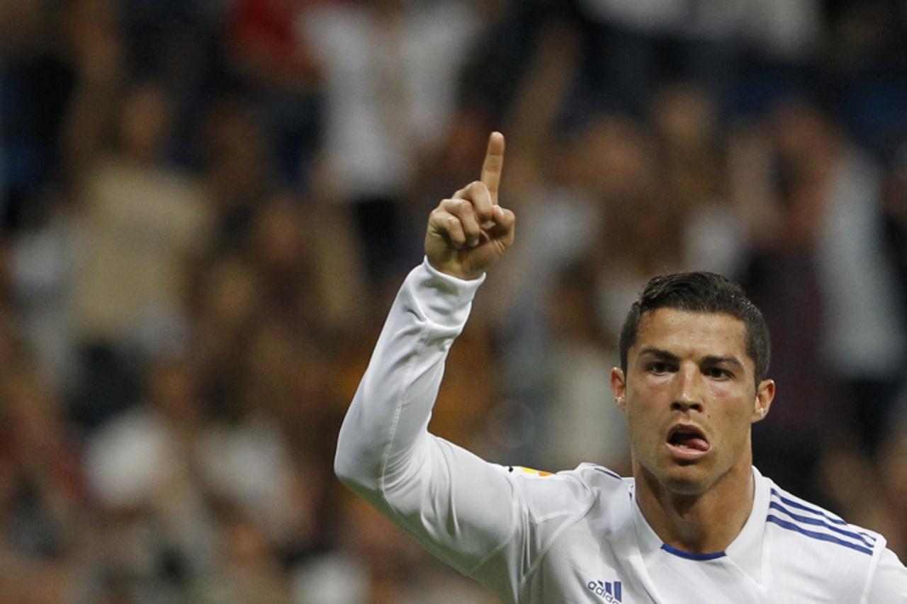'Real Madrid\'s Cristiano Ronaldo celebrates his goal against Getafe during their Spanish first division soccer match at Santiago Bernabeu stadium in Madrid May 10, 2011. REUTERS/Susana Vera (SPAIN - 