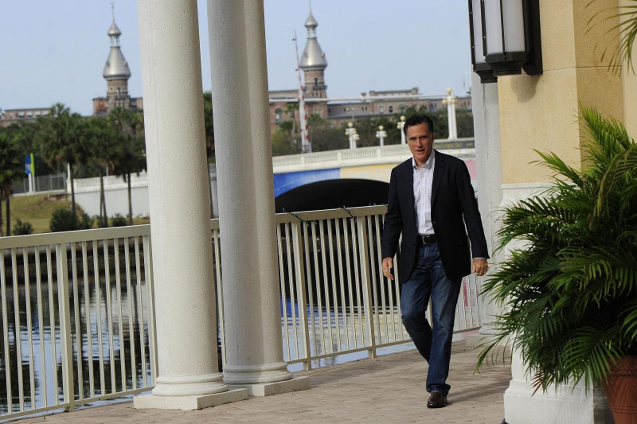 'Republican presidential hopeful Mitt Romney arrives to talk to the press after holding a round table on housing issues in Tampa, Florida, January 22, 2012. Florida will hold its Republican primary on