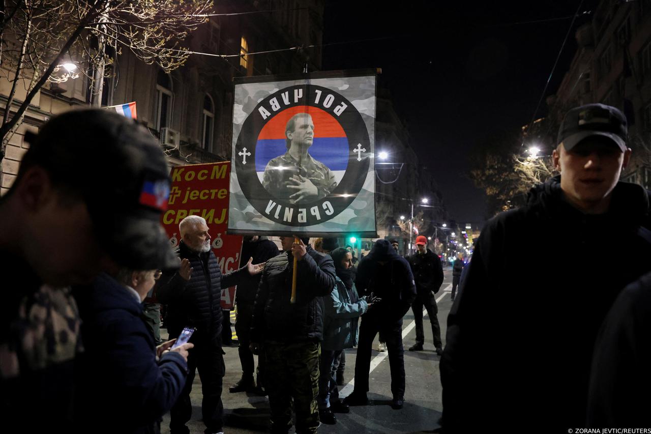 A man holds a banner during a protest against the Serbian authorities and French-German plan for the resolution of Kosovo