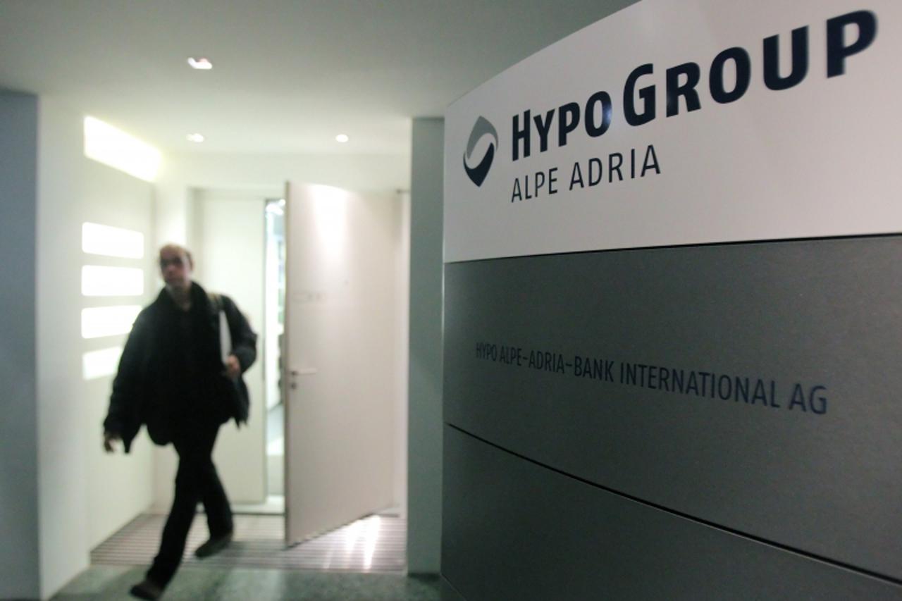 'A man leaves the office of nationalised Austrian lender Hypo Alpe Adria in Vienna March 12, 2013. Hypo Alpe Adria boost its total capital ratio to 13.0 percent at the end of 2012, above the level req