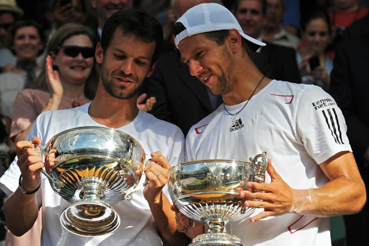 'Jurgen Melzer (R) of Austria and Philipp Petzschner of Germany celebrate after beating Robert Lindstedt of Sweden and Horia Tecau of Romania 6-1, 7-5, 7-5, in the Men\'s Doubles Final at the Wimbledo