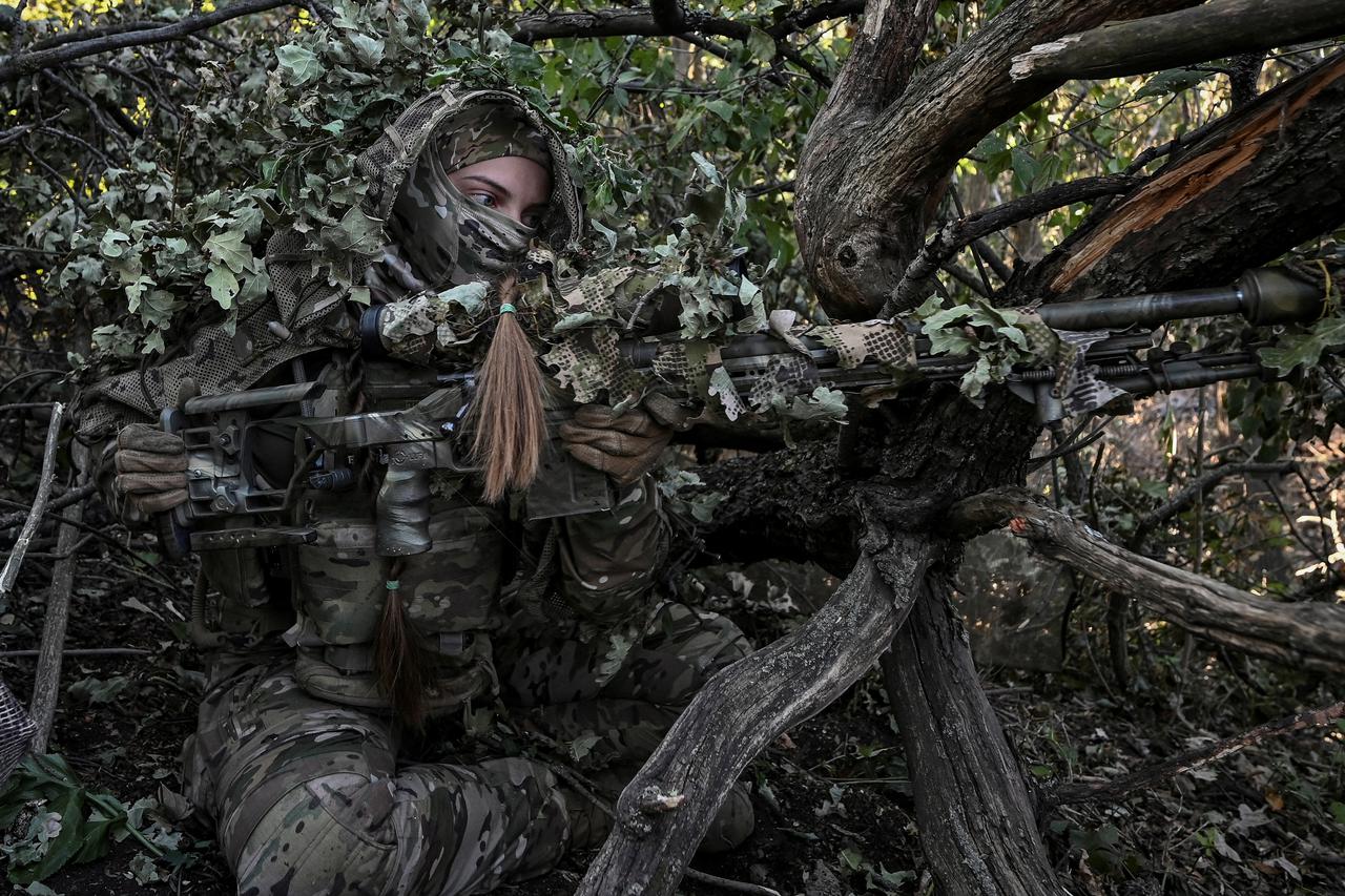 A sniper of Ukraine's 3rd Separate Assault Brigade takes a position during a reconnaissance mission near Bakhmut