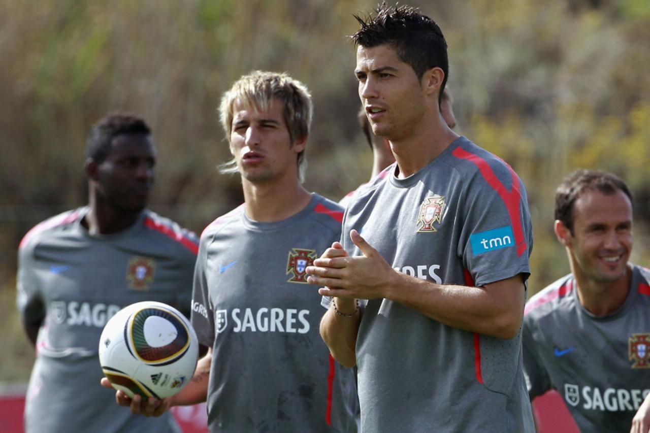 'Portugal\'s players (L to R) Varela, Fabio Coentrao, Cristiano Ronaldo and Ricardo Carvalho attend their training session in Obidos August 31, 2011. Portugal will play their Euro 2012 qualifying socc