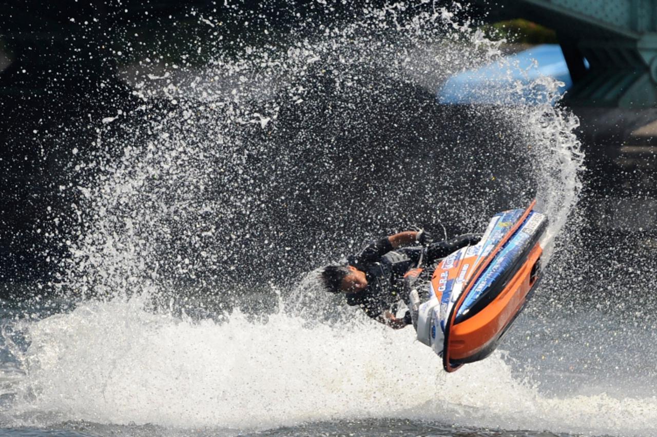 'Ichikawa Naoki performs on his Jet Ski performs as an exhibition to attract people to visit Asakusa shopping and amusement district at the Sumida River Festival in Tokyo on June 6, 2010.     AFP PHOT