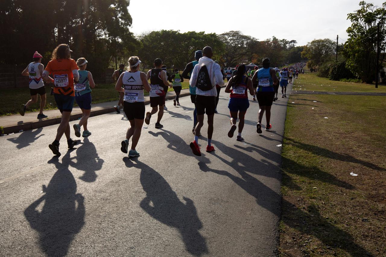Runners competing in the Comrades Marathon pass through Camperdown