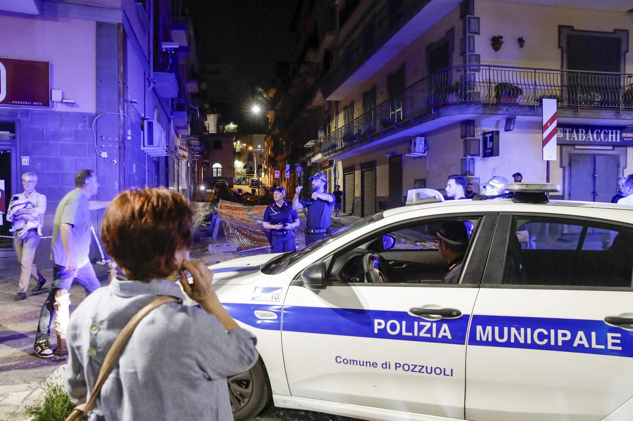 People gather in a safe area in the street on the seafront between Naples and Pozzuoli after an earthquake tremor in the evening. According to the National Institute of Geophysics and Volcanology, the 4.4 magnitude earthquake occurred at 8.10pm local time