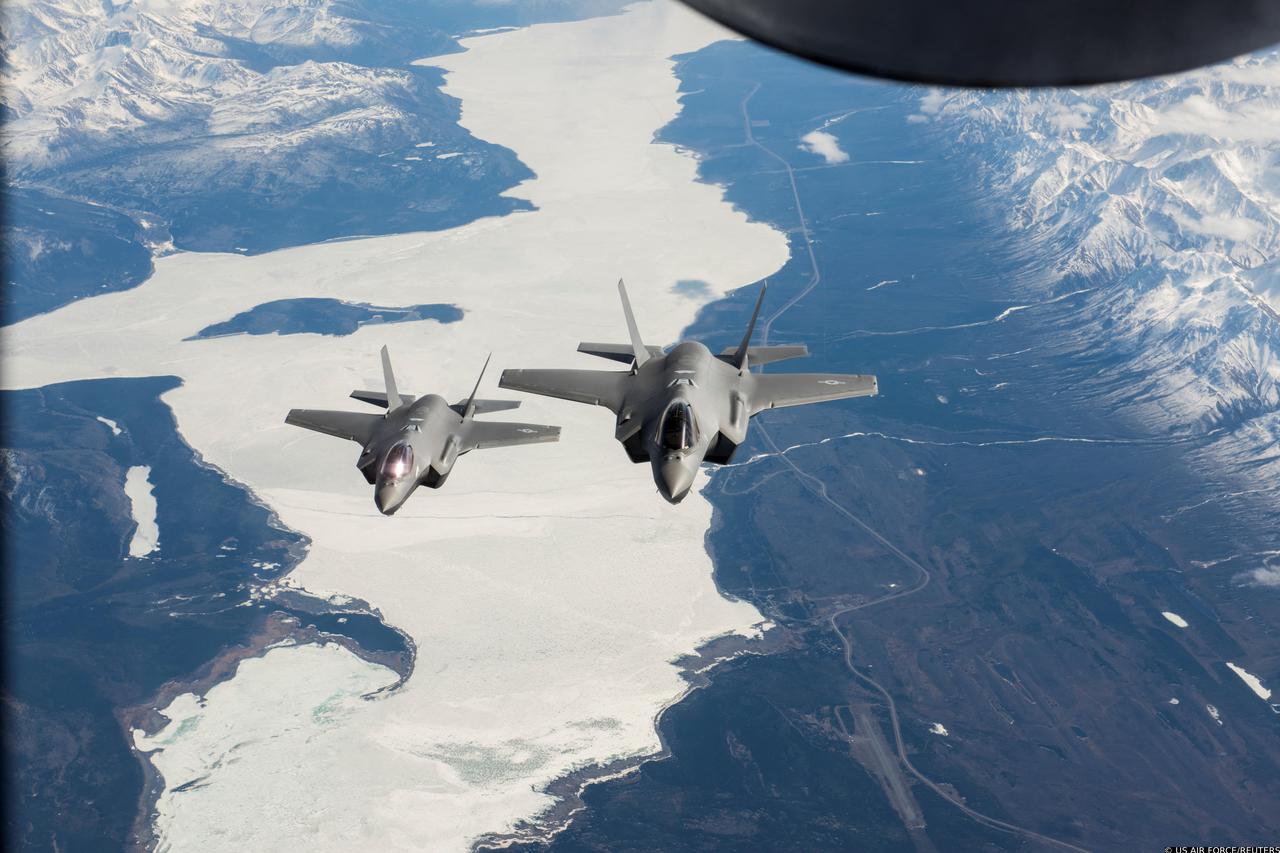Two U.S. Air Force F-35A Lightning II fighter aircraft fly over the Alaska-Canada Highway