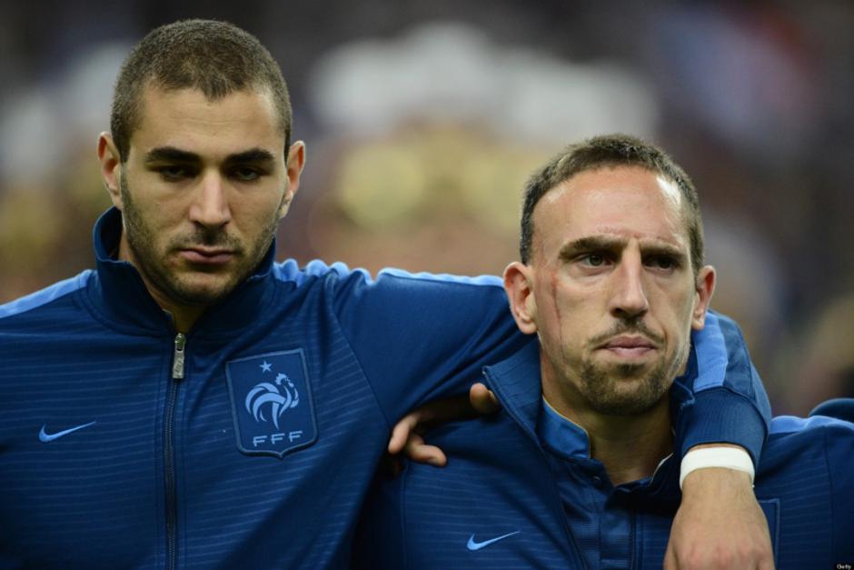 'French forward Franck Ribery (R) and French forward Karim Benzema listen to their national Anthem prior to the World Cup 2014 qualifying football match France vs Belarus, on September 11, 2012 at the