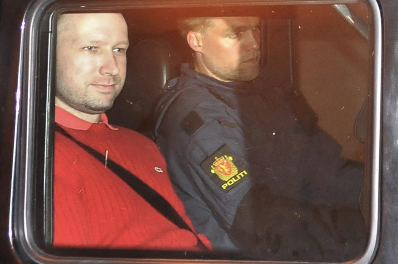 \'Norwegian Anders Behring Breivik (L), the man accused of a killing spree and bomb attack in Norway, sits in the rear of a vehicle as he is transported in a police convoy as he is leaving the courtho