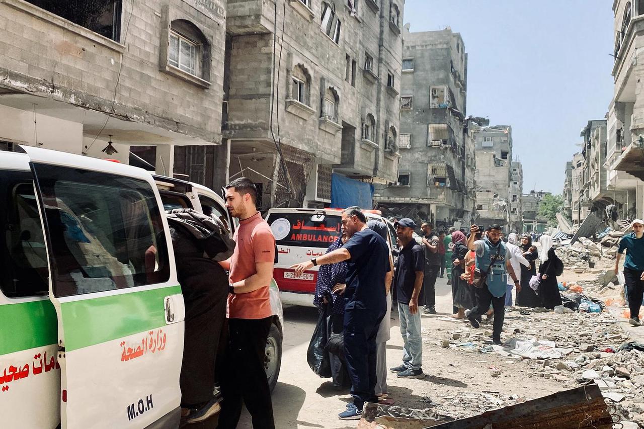 Palestinians evacuate Kamal Adwan hospital following an Israeli strike, in Beit Lahia