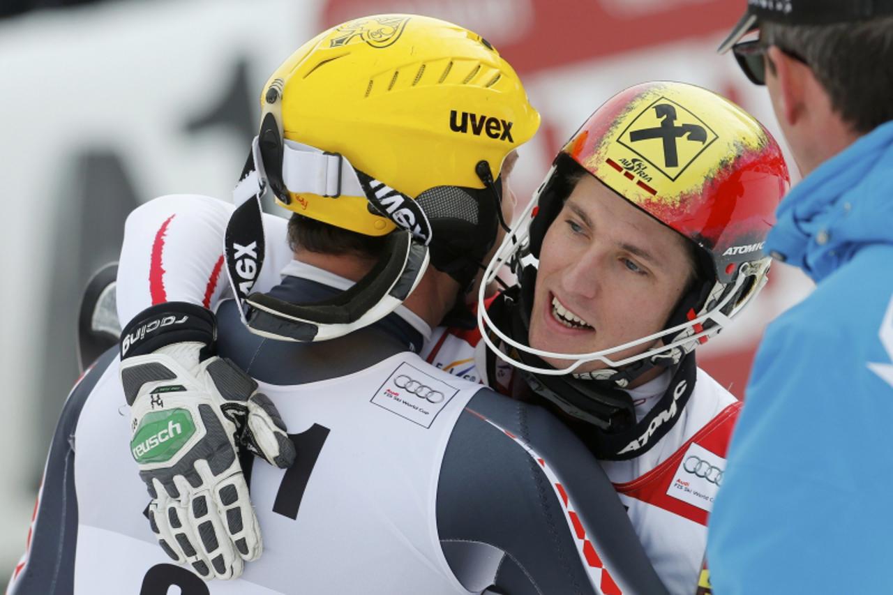 'Third placed Ivica Kostelic of Croatia embraces winner Marcel Hirscher (R) of Austria after the second run of men\'s Slalom event of the Alpine Skiing World Cup downhill ski race in Kitzbuehel Januar