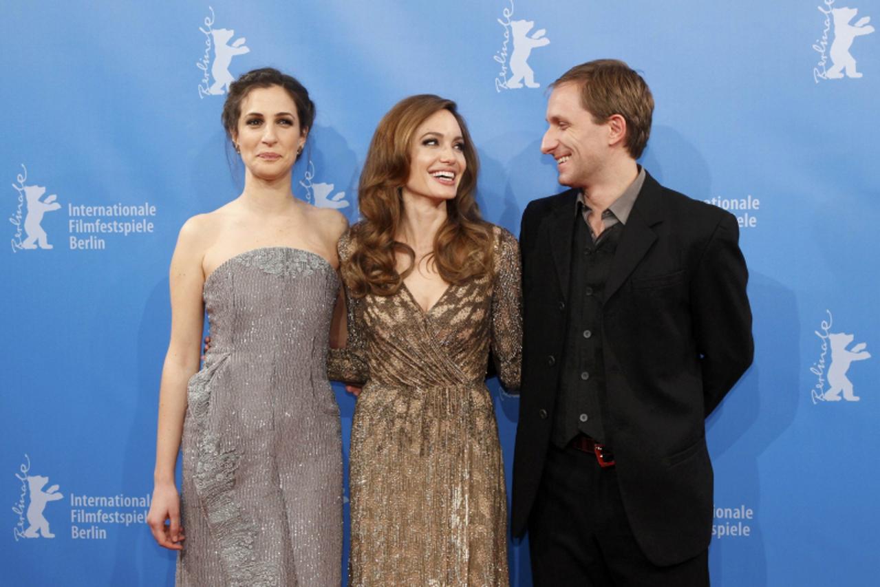 'U.S. actress and director Angelina Jolie (C) and cast members Zana Marjanovic (L) and Goran Kostic (R) arrive for the screening of the movie \'In the Land of Blood and Honey\' at the 62nd Berlinale I