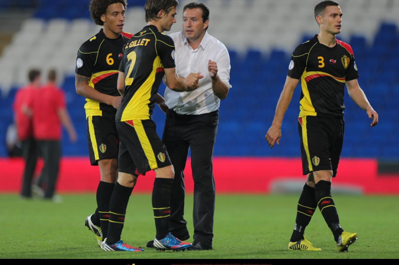 'Belgium Manager Marc Wilmots celebrates after their 2-0 win with Guillaume Gillet and Axel Witsel (left) during the 2014 Fifa World Cup Qualifying match at the Cardiff City Stadium, Cardiff. Photo: P