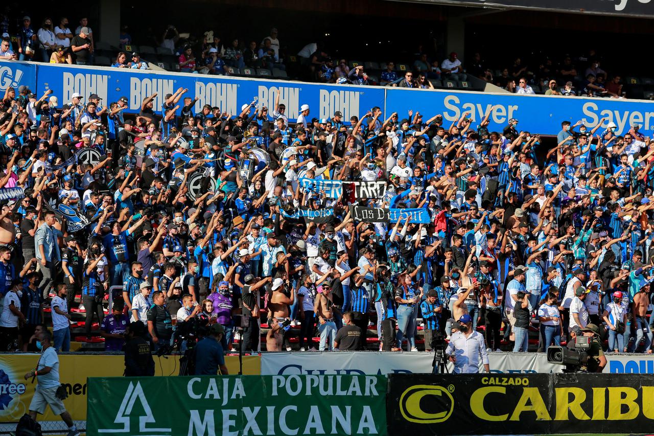 Fans cheer on the stands at the Corregidora stadium in Queretaro