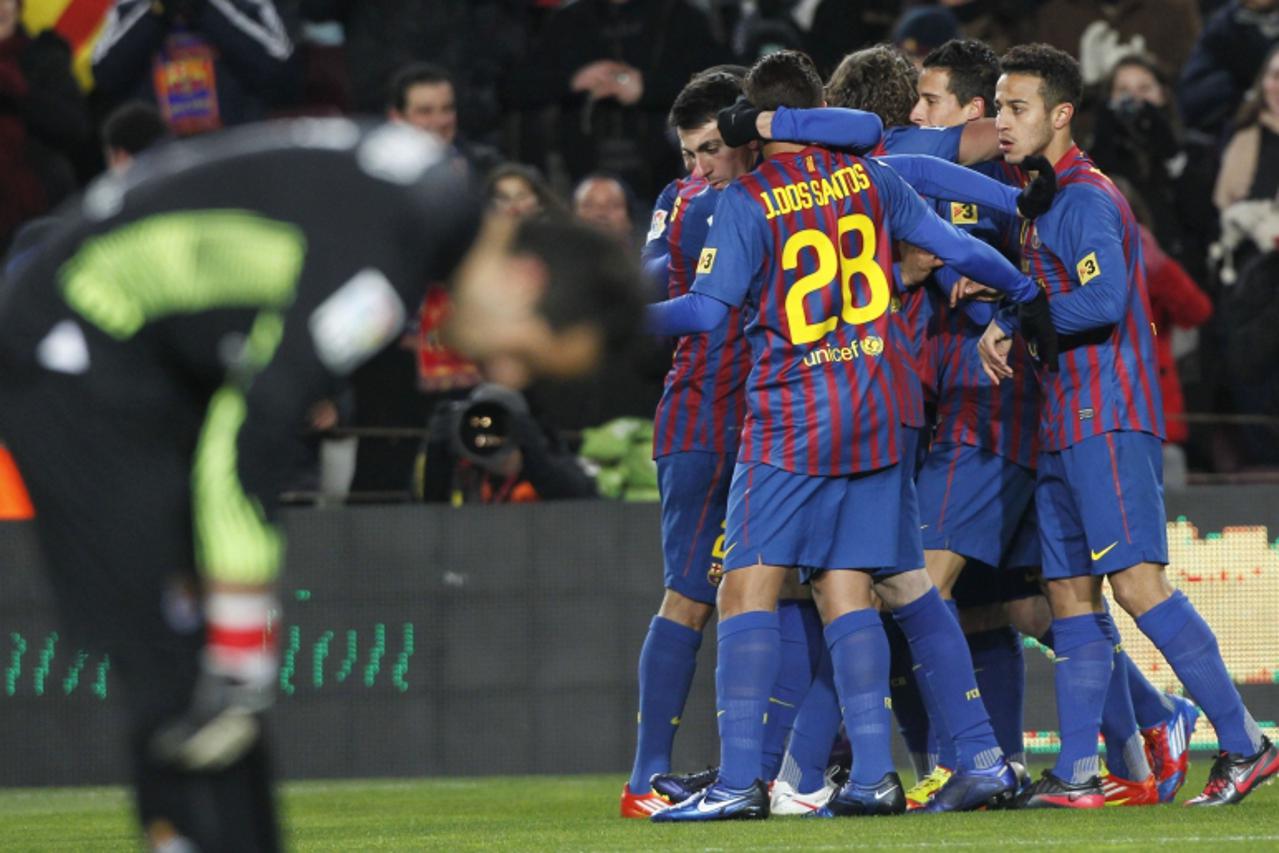 'Barcelona\'s players celebrate Cristian Tello\'s goal against Real Sociedad during their Spanish first division soccer match at the Nou Camp stadium in Barcelona,February 4, 2012.   REUTERS/Albert Ge
