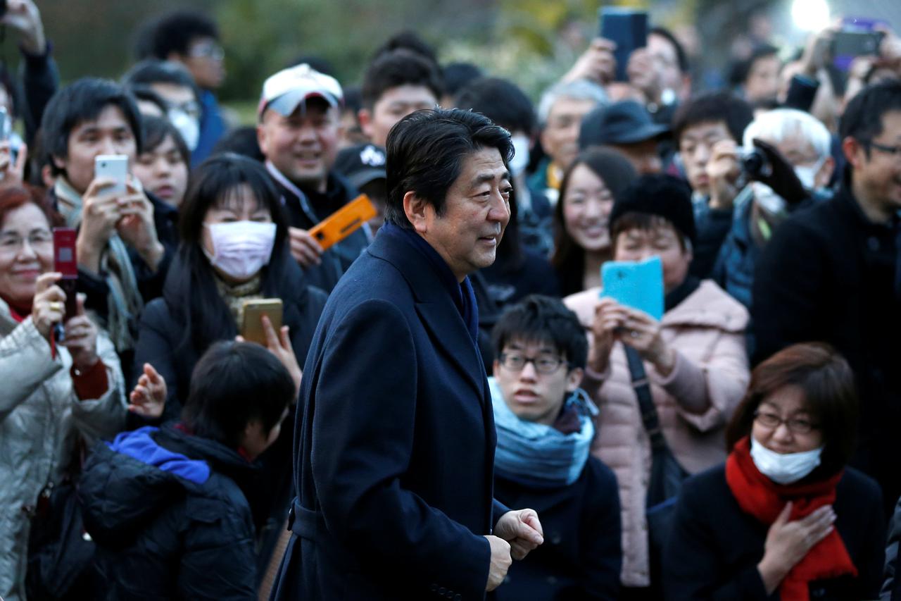 People take pictures of Japan's Prime Minister Shinzo Abe as he attends a Friday night concert outside a museum in Tokyo, Japan February 24, 2017.     REUTERS/Toru Hanai