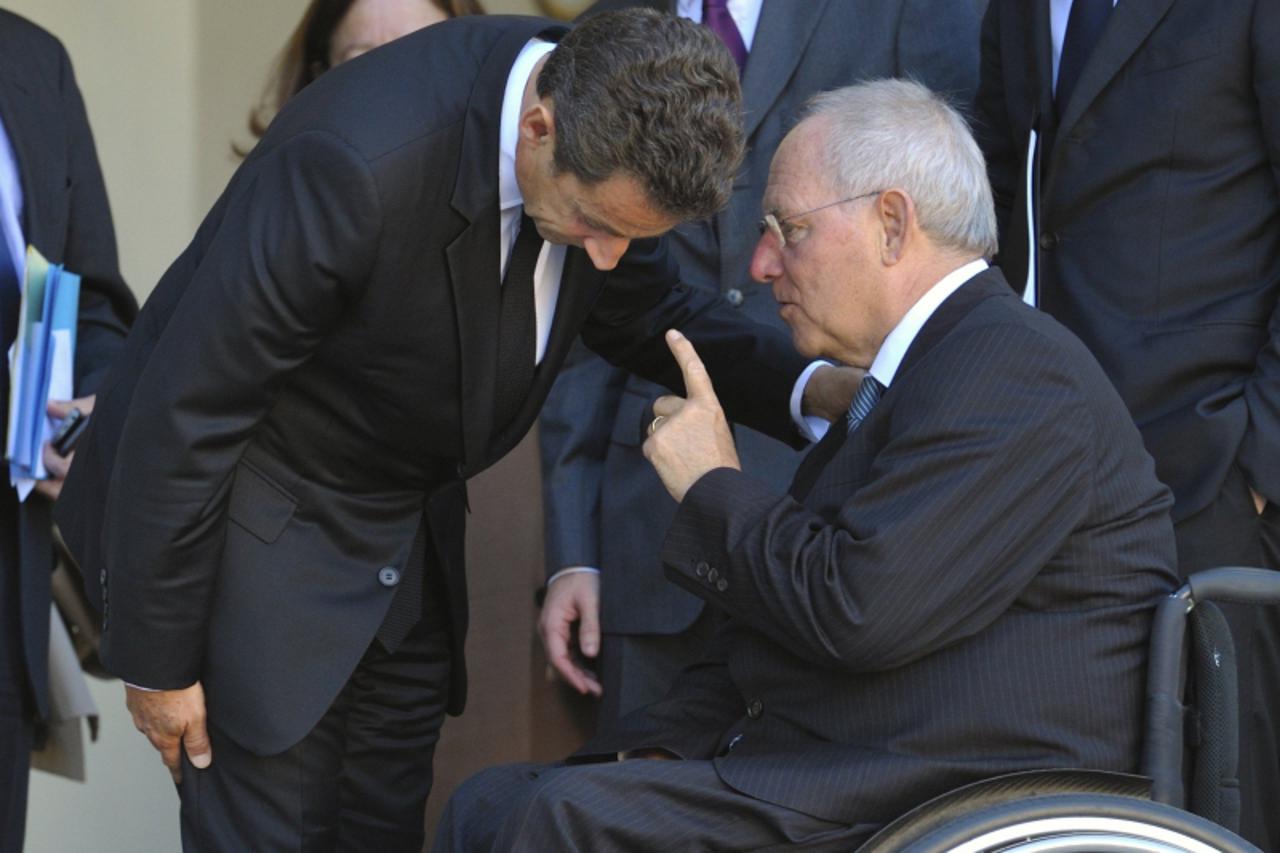 'France\'s President Nicolas Sarkozy (L) listens to German Finance Minister Wolfgang Schauble after a meeting at the Elysee Palace in Paris, October 14, 2011.  REUTERS/Philippe Wojazer  (FRANCE - Tags