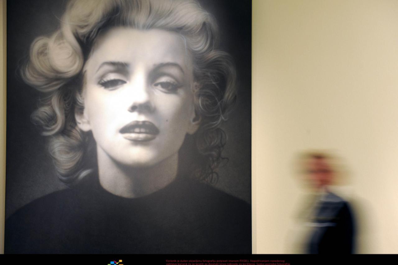 'An employee of the East Frisian State Museum walks past a painting of Russian artist Alexander Timofeev inspired by a photography of U.S. actress Marilyn Monroe made in 1952 in Emden, Germany, 15 Mar