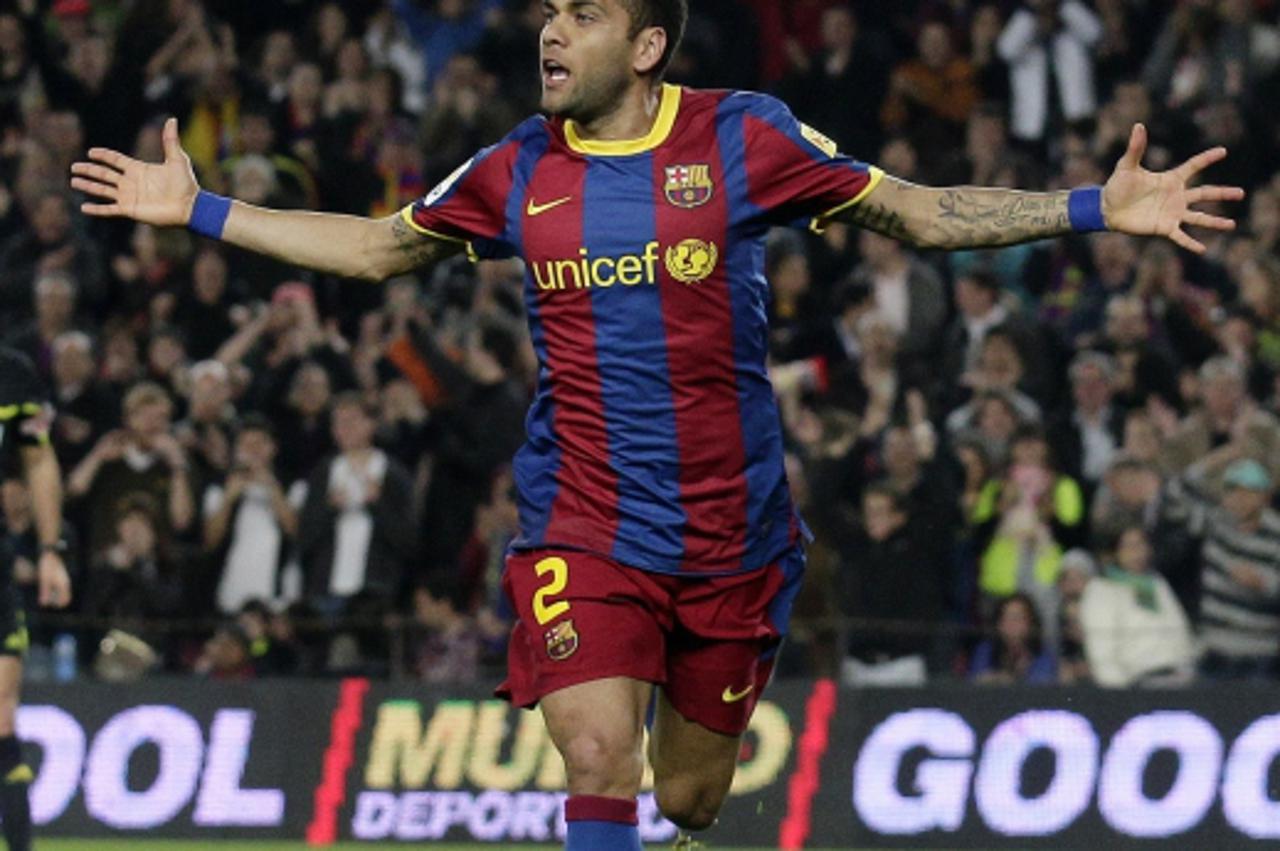'Barcelona\'s Dani Alves celebrates a goal against Getafe during their Spanish First division soccer league match at Camp Nou stadium in Barcelona, March 19, 2011. REUTERS/Albert Gea (SPAIN - Tags: SP