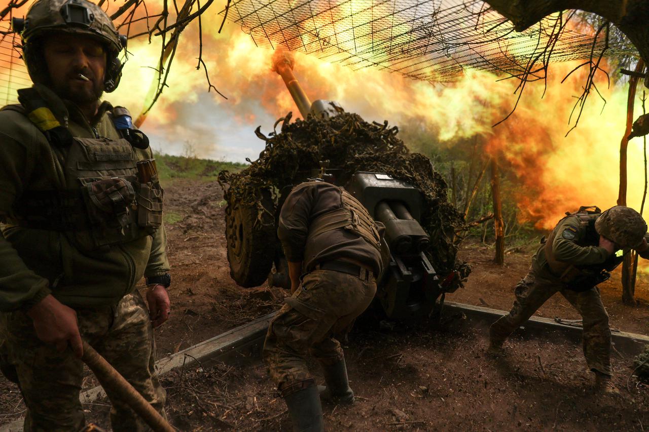 Ukrainian servicemen of the 10th Mountain Assault Brigade 'Edelweiss' fire a D-30 howitzer towards Russian troops at a position in a front line, amid Russia's attack on Ukraine, near the town of Soledar, Donetsk region, Ukraine
