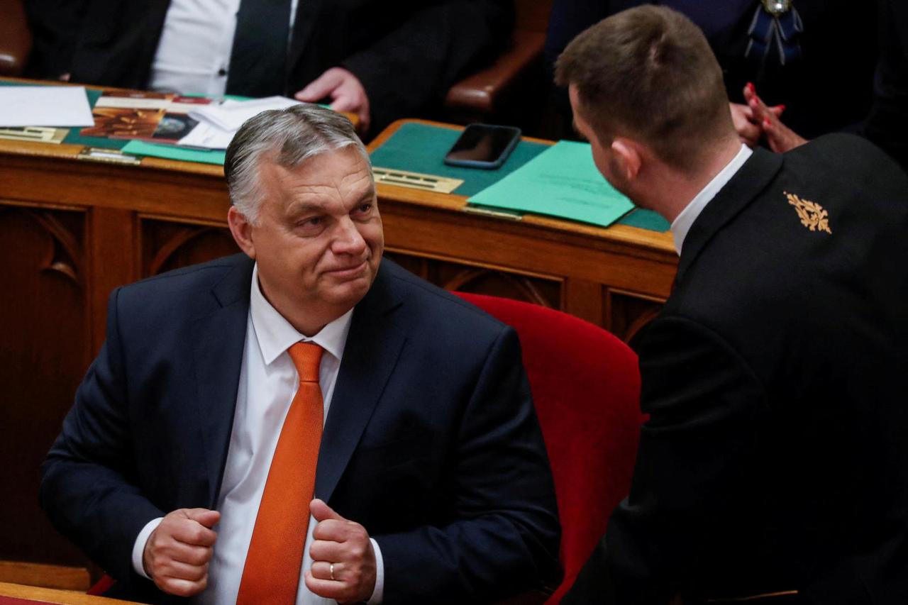 Hungarian Prime Minister Orban talks with an aide during the opening session of Hungary's new parliament, in Budapest