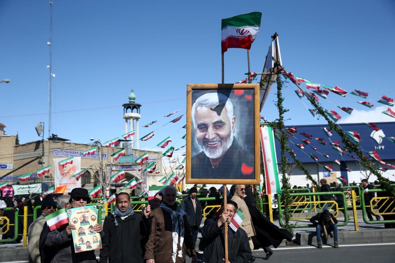 FILE PHOTO: An Iranian man holds a picture of the late Iran's Quds Force top commander Qassem Soleimani, during the commemoration of the 41st anniversary of the Islamic revolution in Tehran